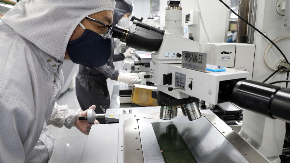 FILE PHOTO: A worker inspects semiconductor chips at the chip packaging firm Unisem (M) Berhad plant in Ipoh <i>Lim Huey Teng/Reuters</i>