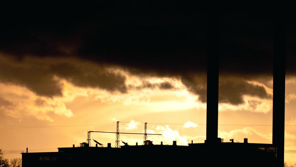 Industrial plant spewing out fumes from three chimneys
