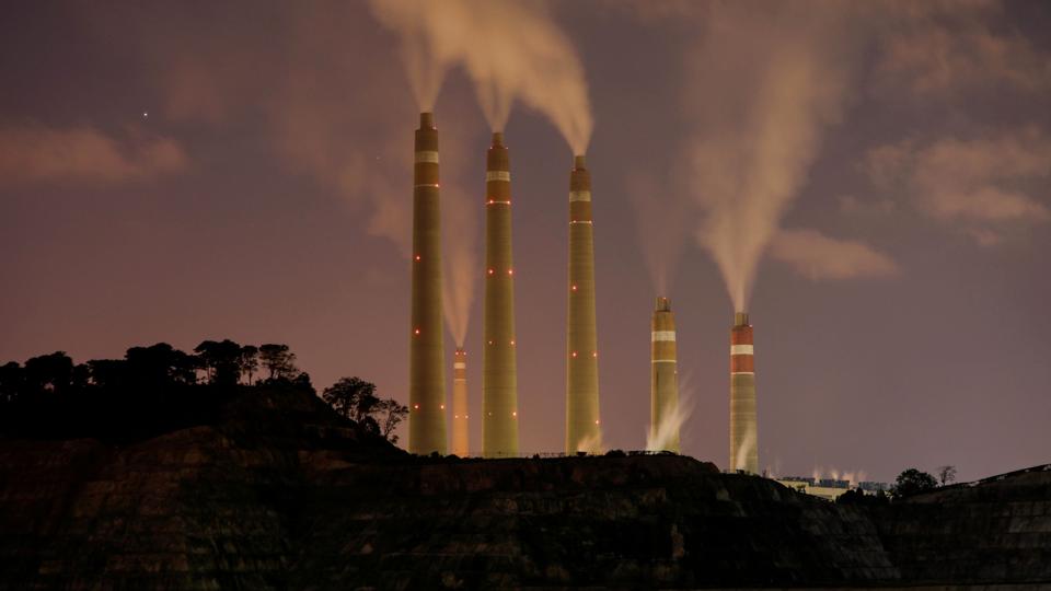 FILE PHOTO: FILE PHOTO: Smoke and steam billows from the coal-fired power plant owned by Indonesia Power, next to an area for Java 9 and 10 Coal-Fired Steam Power Plant Project in Suralaya <i>Willy Kurniawan/Reuters</i>