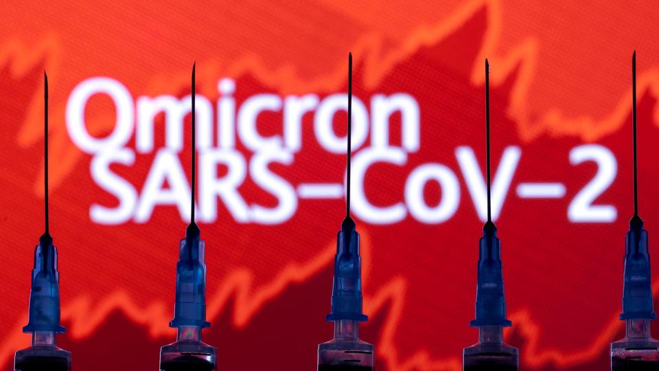 FILE PHOTO: yringes with needles are seen in front of a displayed stock graph and words <i>Dado Ruvic/Reuters</i>