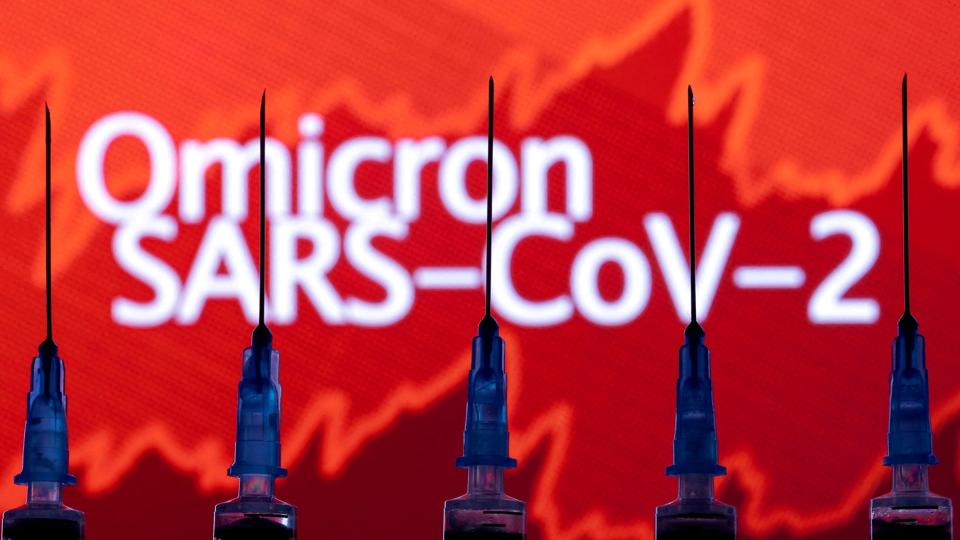 FILE PHOTO: Syringes with needles are seen in front of a displayed stock graph and words <i>Dado Ruvic/Reuters</i>