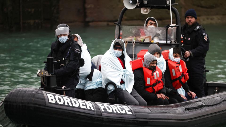 Migrants arrive into the Port of Dover onboard a Border Force vessel after being rescued while crossing the English Channel, in Dover <i>Henry Nicholls/Reuters</i>