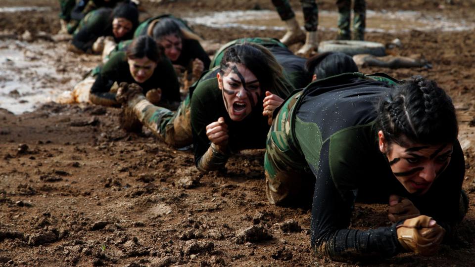 Members of Kurdish Peshmerga Special Forces demonstrate their skills during their graduation ceremony at a military camp in Soran district, in Erbil province <i>Azad Lashkari/Reuters</i>