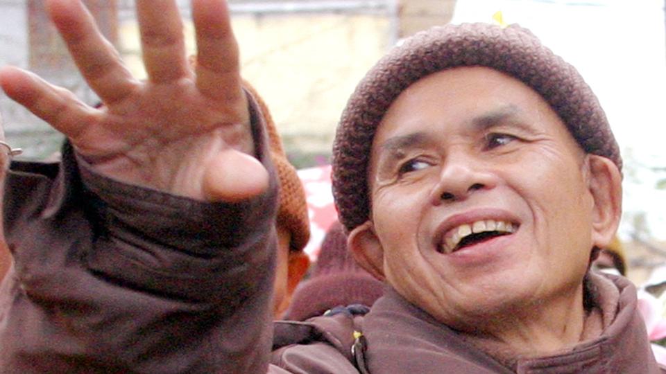 FILE PHOTO: French-Vietnamese Buddhist monk Thich Nhat Hanh waves to the crowd at the Bo De pagoda in Hanoi. <i>Stringer/Reuters</i>