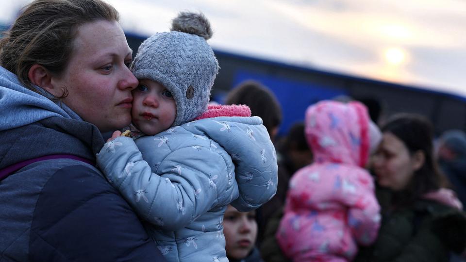 En ukrainsk kvinde på flugt sammen med sit barn i den polske by Przemysl. De er blandt de foreløbigt 660.000 ukrainere, der er flygtet under den russiske invasion. <i>Kai Pfaffenbach/Reuters</i>