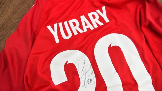 Før Santiago mødte Frederik, kendte han kun til én anden dansker: Landsholdsspilleren Yussuf Yurary Poulsen. Santiago er fan af bundesligaholdet RB Leipzig, hvor Yurary spiller til daglig, og derfor heppede han på Danmark, da han sad og så Danmark spille 0-0 mod England 8. september i København. Frederik så ikke kampen, for lige præcis den dag rejste han hjem til Danmark. men det er lykkedes ham at skaffe Yurarys signerede spillertrøje fra kampen. Den vil Frederik forære Santiago som tak for al hans hjælp.