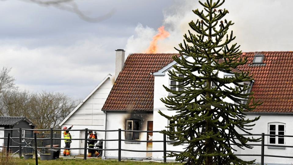Der står kraftige flammer ovenud af taget på den brændende bygning. Foto: Henrik Bo
