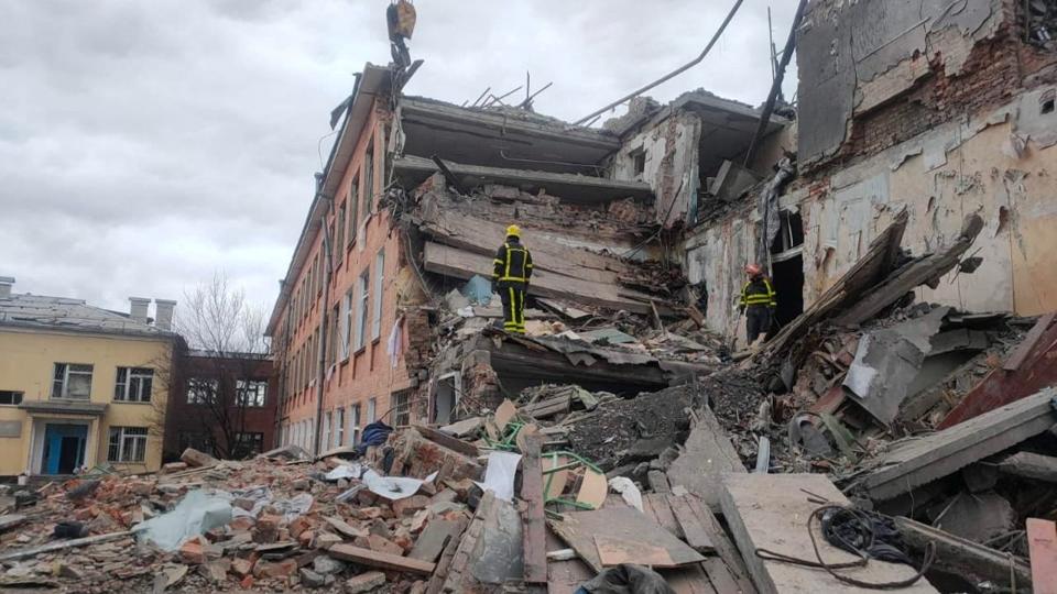 Redningsfolk fjerner mandag murbrokker ved en skole i byen Tjernihiv, som er stærkt beskadiget af bombardementer. <i>State Emergency Service/Reuters</i>