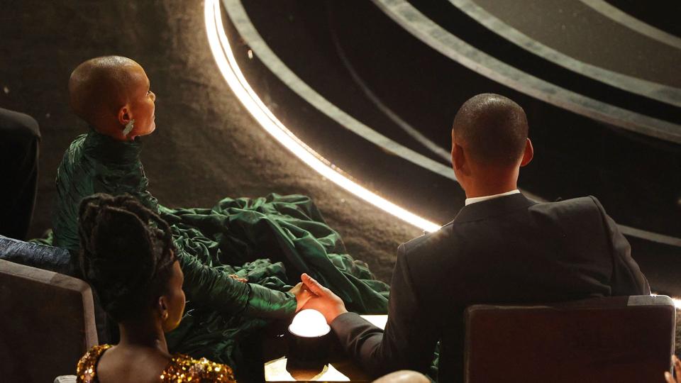 Will Smith (til højre) forlod sin plads for at give Chris Rock en lussing, efter at Rock havde lavet en joke om Will Smiths hustru Jada Pinkett Smiths (til venstre) skaldethed. <i>Brian Snyder/Reuters</i>