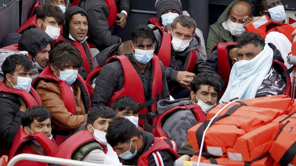 En gruppe migranter bliver bragt i land i Dover, England, efter at være blevet opsnappet af britiske myndigheder, efter at de har krydset Den Engelske Kanal. Personerne på billedet er blandt de rekordmange, der mandag krydsede kanalen. <i>Gareth Fuller/Ritzau Scanpix</i>