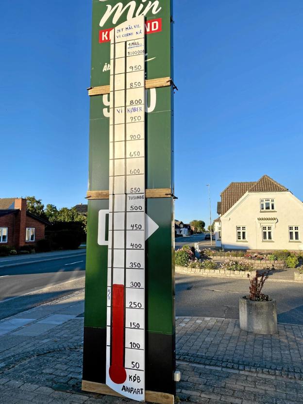 Ole Holmsgaard, som er tidligere malermester, har lavet et barometer, der er blevet sat op uden for købmandsforretningen, så borgerne kan følge med i, hvor mange penge, de har købt anparter for. Foto: Bitten Holmsgaard