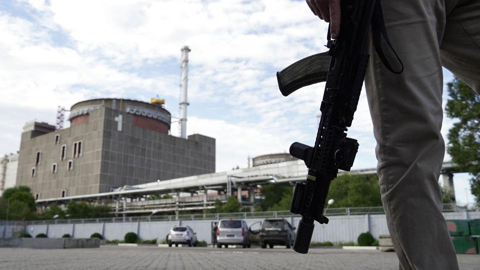 En bevæbnet vagt står udenfor atomkraftværket Zaporizjzja i Ukraine. Værket er Europas største og blandt de ti største i verden. For knap to uger besøgte inspektører fra IAEA værket og anbefalede efterfølgende, at der oprettes en sikkerhedszone omkring det. <i>Stringer/Ritzau Scanpix</i>