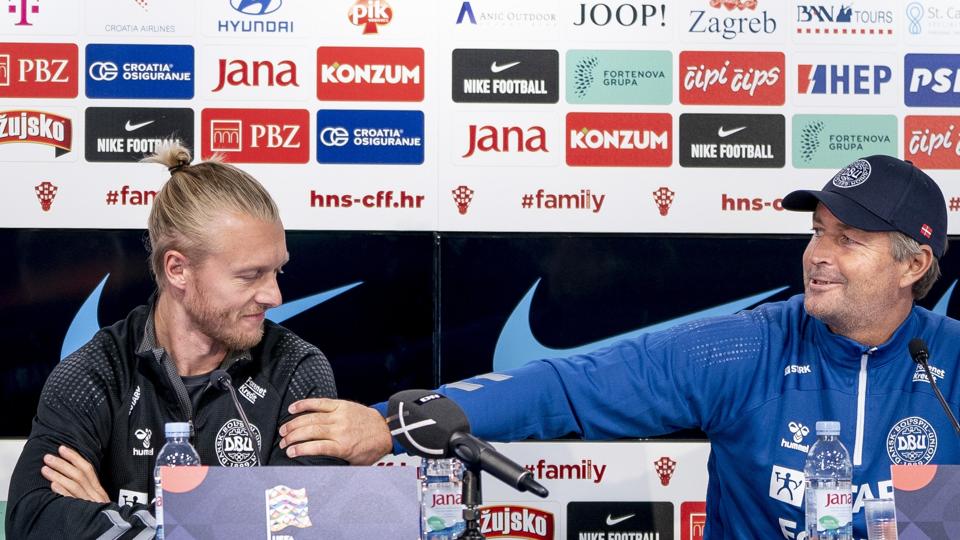 Kasper Hjulmand byder Simon Kjær velkommen tilbage på fodboldlandsholdet og holder på det område, hvor anførerbindet normalt sidder på den blonde stopper. <i>Liselotte Sabroe/Ritzau Scanpix</i>