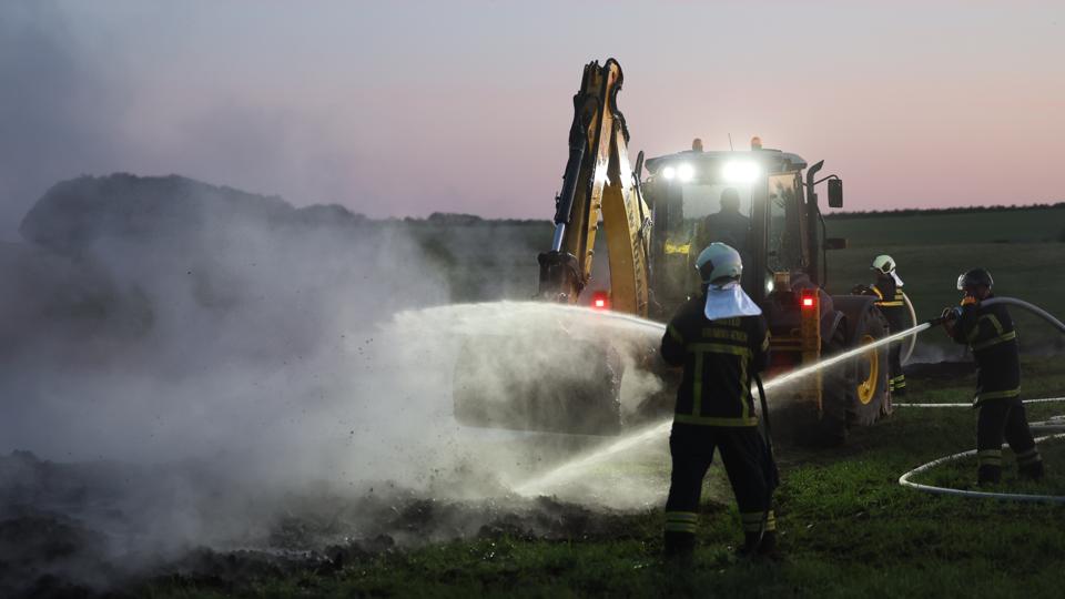 Nordjyllands Beredskab må bruge en rendegraver til at hjælpe med slukningsarbejdet til en underjordisk brand nord for Snedsted. <i>Foto: Bo Lehm</i>