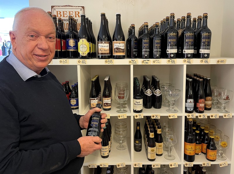 Mogens Kristensen med en af de mange belgiske øl, der er i butikken.  
